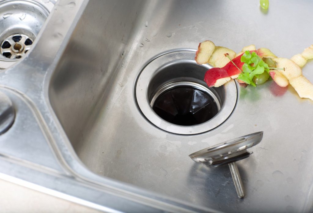 stopped up kitchen sink with disposal